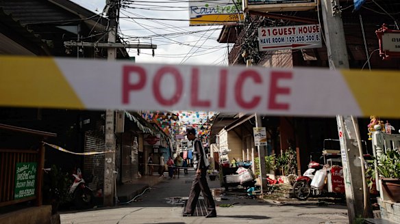 A police officer stands at the site of an explosion in Hua Hin, Thailand, on August 12, one of a series of blasts that coincided with the Thai queen's birthday.  