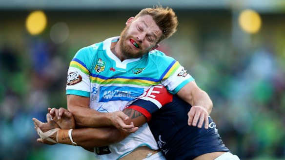 Elliot Whitehead of the Raiders is tackled after offloading.