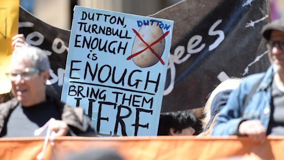 'Bring them here' reads a protester's sign in support of asylum seekers on Manus Island.