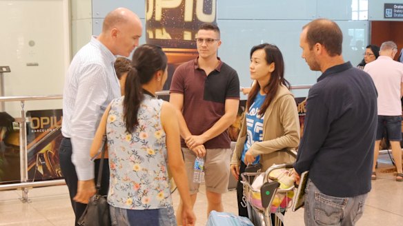 Family and friends of Suria Intan, including Emi Intan, are met by consular officials at Barcelona airport on Saturday.