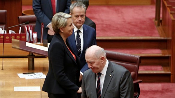 Ms Plibersek looks bemused as Sir Peter passes her by.