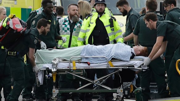 Emergency services staff provide medical attention to injured people.