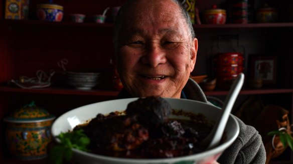 Peranakan Place owner Sam Wong with his dish ayam bush keluak (chicken braised with keluak nuts).