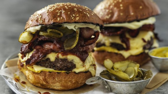 Towering triple cheese and bacon burgers.