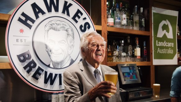 Bob Hawke pours a glass of his namesake brew.