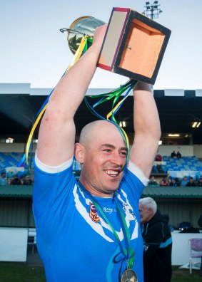 Queanbeyan Blues captain-coach Terry Campese holds the Canberra Raiders Cup trophy aloft after Sunday's grand final win over Queanbeyan Kangaroos.