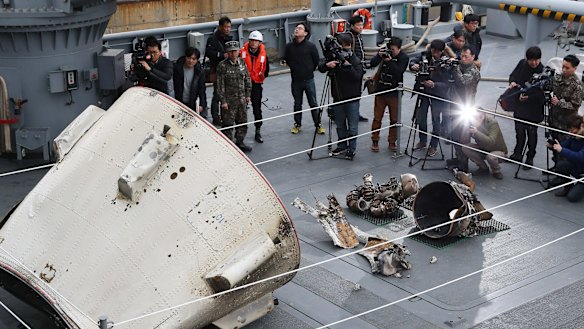 Objects believed to be part of a North Korean rocket are displayed for the media on a South Korean navy ship in Pyeongtaek, south of Seoul.