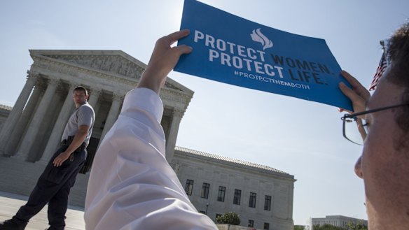 An anti-abortion activist stands in front of the Supreme Court in Washington as the judges struck down the strict Texas anti-abortion restriction law known as HB2. 