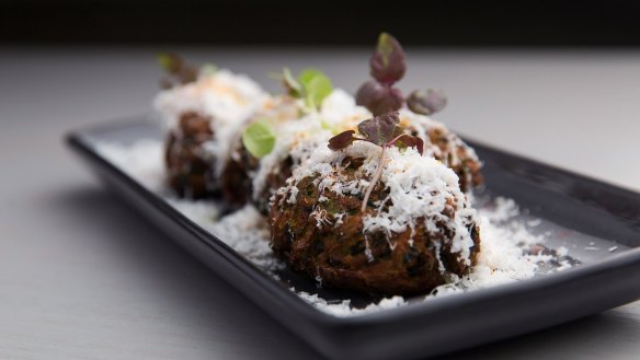 Zucchini croquettes scattered with ricotta salata.