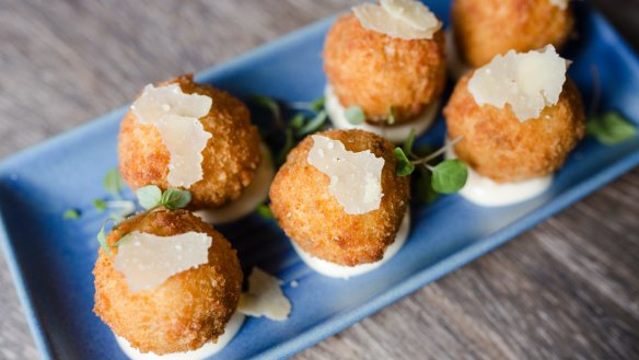 Arancini balls are filled with mushrooms, pumpkin and goat's cheese, with a panko crust,
