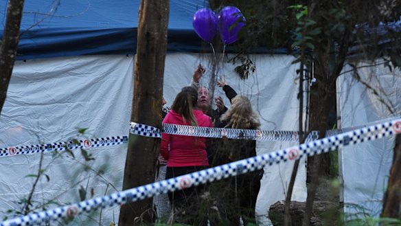 Mark Leveson (second from right) and Faye Leveson (right) release balloons with friends at the crime scene.