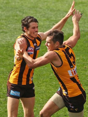 Luke Hodge celebrates a goal with Isaac Smith duuring last year's grand final.