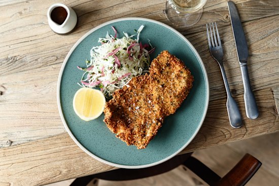 Parmesan-and-herb-crumbed chicken schnitzel.