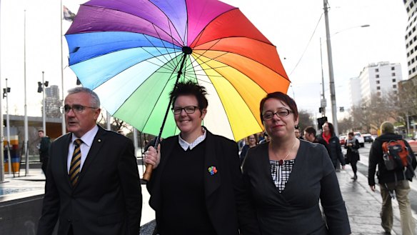 Mother-of-three Felicity Marlowe (centre) and her partner Sarah Marlowe with MP Andre Wilkie after appearing for a High Court injunction hearing application against the voluntary same-sex marriage postal survey.