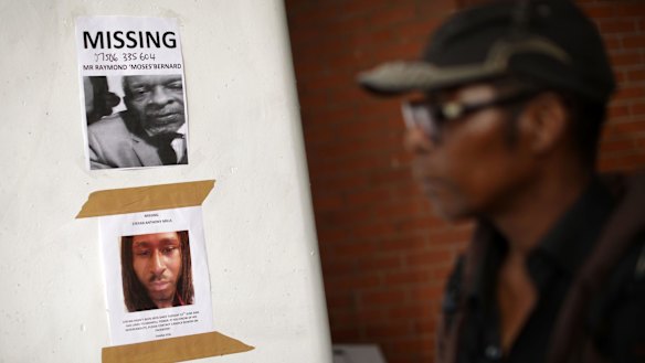 Posters for missing people on a wall near the apartment block on Thursday.