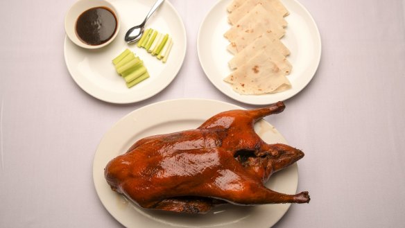 The signature Peking duck is presented tableside, then whisked off and assembled into pancakes.