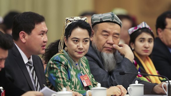 Delegates from Xinjiang attend the Xinjiang group meeting at the Great Hall Of The People in Beijing on March 12.