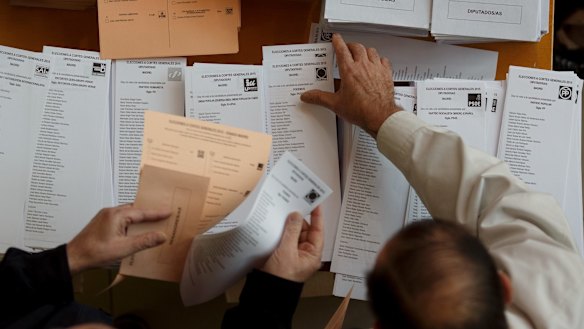 Spanish voters  collect their ballot papers at a polling station in Madrid on Sunday.
