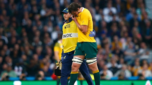 Dejected: Kane Douglas is helped from the field.