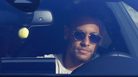 Sad goodbye: Neymar in his car outside Barcelona's training grounds on Wednesday.