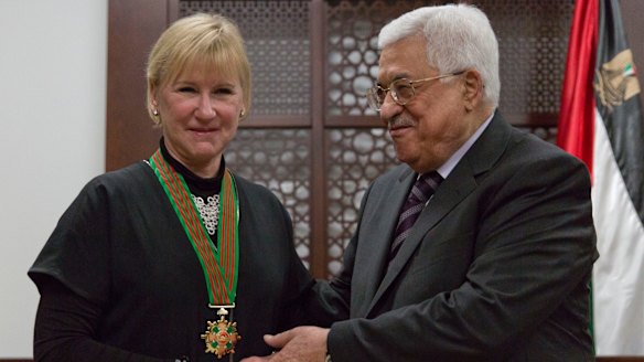 Mahmoud Abbas decorates Swedish Foreign Minister Margot Wallstrom with the "Grand Star of the Order of Jerusalem" at his office in Ramallah on December 15. Israeli officials have boycotted Ms Wallstrom's visit to the region.
