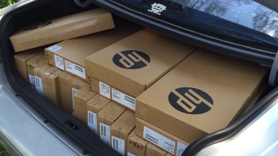 A car boot full of new laptops ready for delivery for new vocational students.