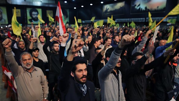 Supporters cheer as they listen to a speech by Hezbollah leader Sayyed Hassan Nasrallah, in Beirut, Lebanon, on Tuesday. Nasrallah said Turkey and Saudi Arabia are using Islamic State as a "pretext" to launch a ground operation in Syria.