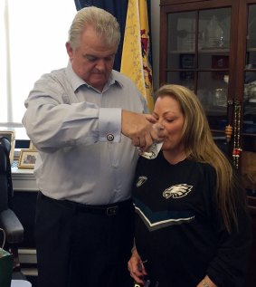 Bob Brady's wife Debra carefully sips from the glass that was used by Pope Francis. 
