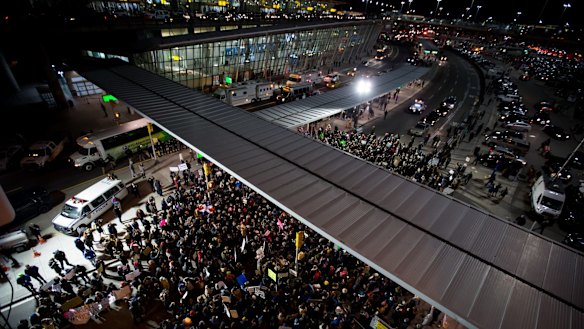 Demonstrators gather outside John F. Kennedy International Airport to protest against US President Donald Trump's executive order.