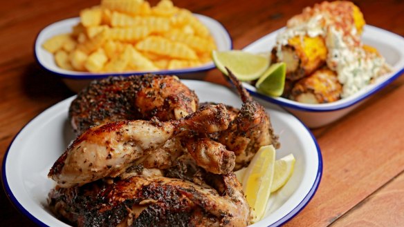 Rotisserie chicken, crinkle-cut chips and a side dish of corn at Henrietta's Chicken Shop & Bar in Melbourne.