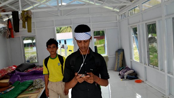 A Rohingya refugee from Myanmar call his family by phone from the Aceh Province, Indonesia.