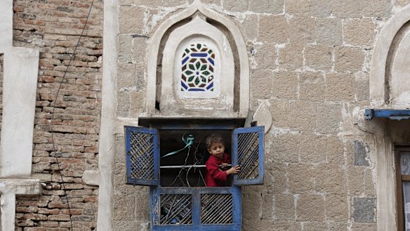 A boy looks out from the window of his house in the Old City in Sanaa, Yemen, earlier this month. 