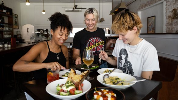 Claire Browne (left) and Otis Clark, right, try chef Lizzie Tillett's vegan and vegetarian food at The Sunshine Inn in Redfern. 