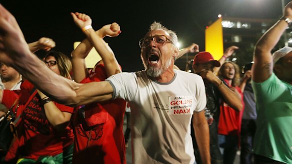 Pro-government supporters chant at a demonstration against the impeachment of Brazilian President Dilma Rousseff outside the National Congress building on Wednesday.