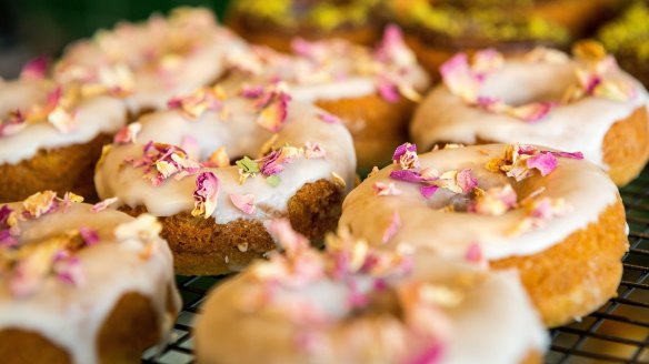 Rows of rose petal-flecked doughnuts.