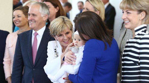 Kelly O'Dwyer's daughter Olivia joined the women in the ministry photo with Prime Minister Malcolm Turnbull on Monday.