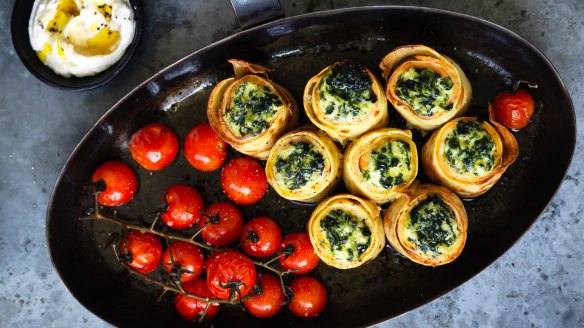 Smoked salmon crepe rolls with roast tomatoes and horseradish cream.