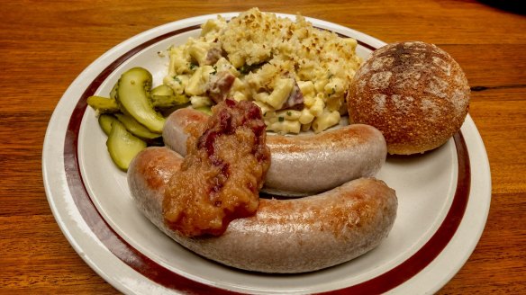 Free-range pork sausages with apple and cranberry relish, pickles and macaroni cheese.