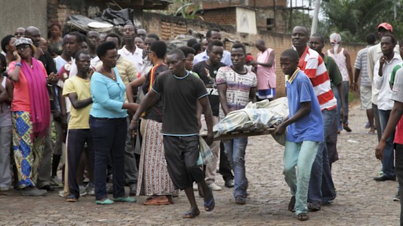 A victim of Friday's violence is stretchered away in the Nyakabiga neighbourhood of Bujumbura.