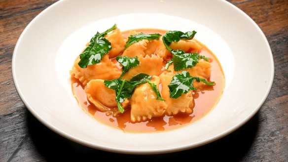Lobster mousseline agnolotti with tomato butter sauce.