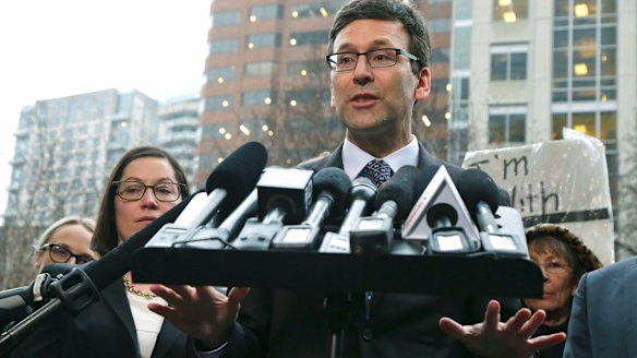 Washington Attorney General Bob Ferguson talks to reporters following the judge's order on Friday.