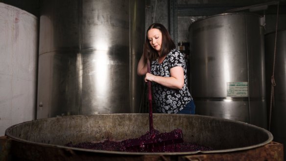 Stephanie Helm demonstrates how to plunge grapes. 