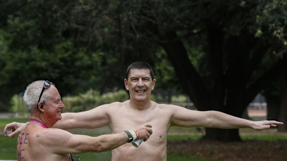 Co-organisers Michael Cowan (left) and Michael (surname withheld) apply sunscreen before the ride.