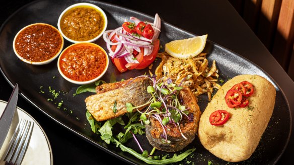 A fish platter with dried whitebait and kenkey.