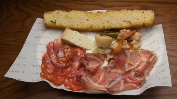 A snacky selection of salumi and cheese with giardiniera pickles.