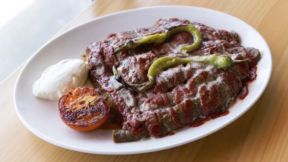 Iskender drizzled with tomato paste and clarified butter.