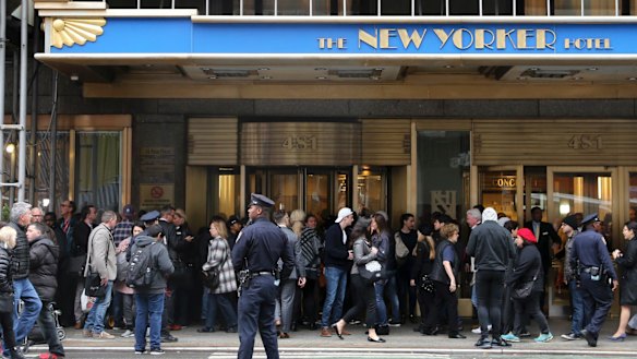 The media and onlookers wait for Clinton at The New Yorker Hotel.