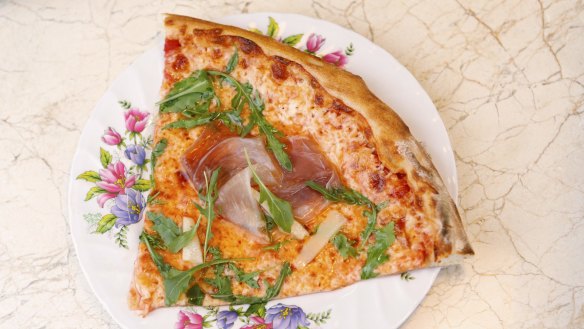 Pizzas are available whole or by the slice (prosciutto pizza pictured).