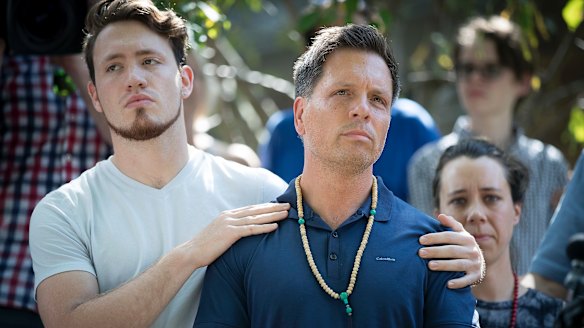 Don Damond is comforted by his son Zach Damond following the death of his fiancee Justine.