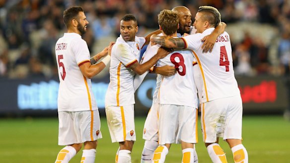 Roma players celebrate after Adem Ljalic scored a late equaliser against Manchester City at the MCG, sending the game to penalties.